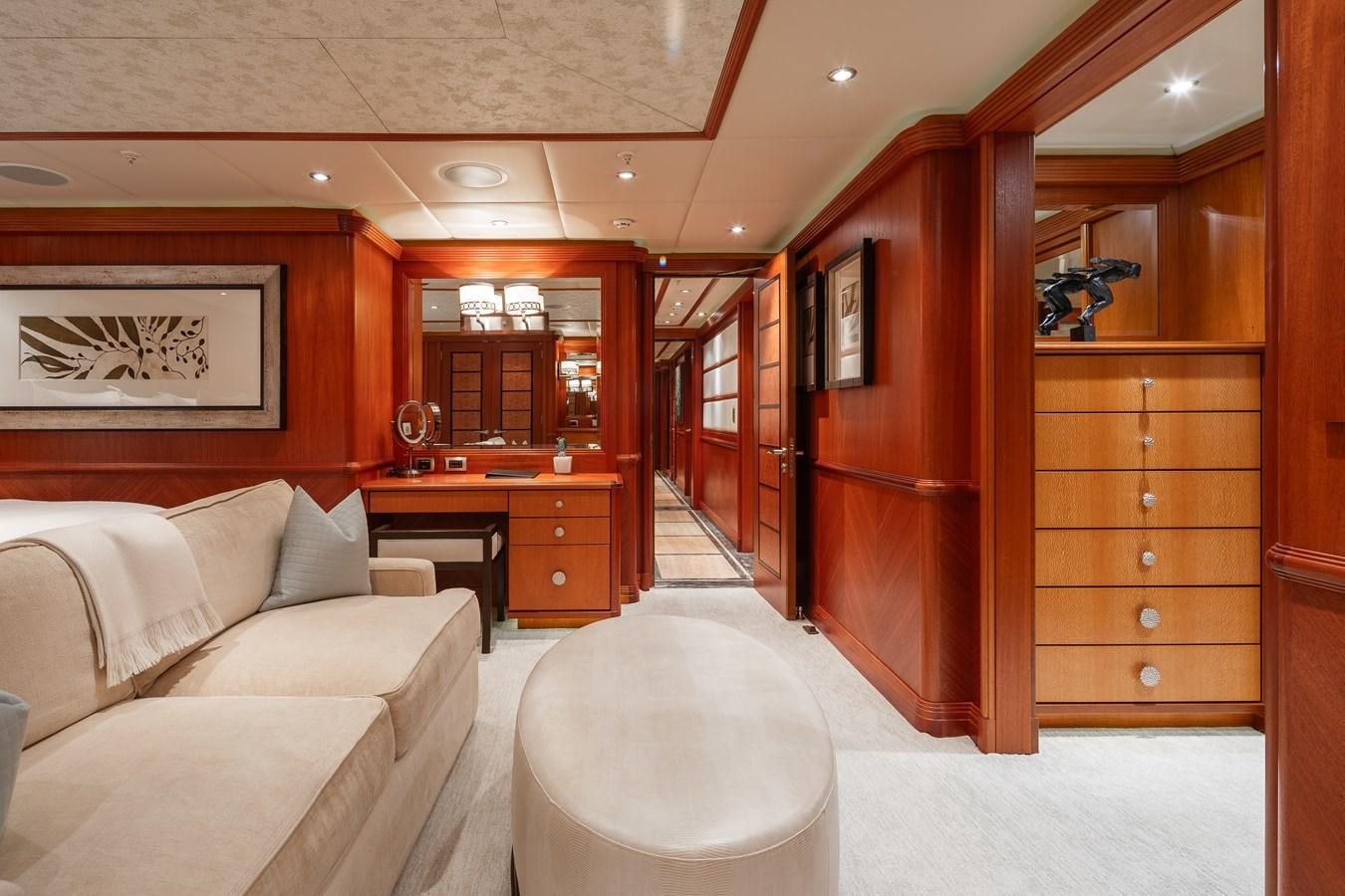 a room with a couch and a wood cabinet aboard SKYFALL Yacht for Sale