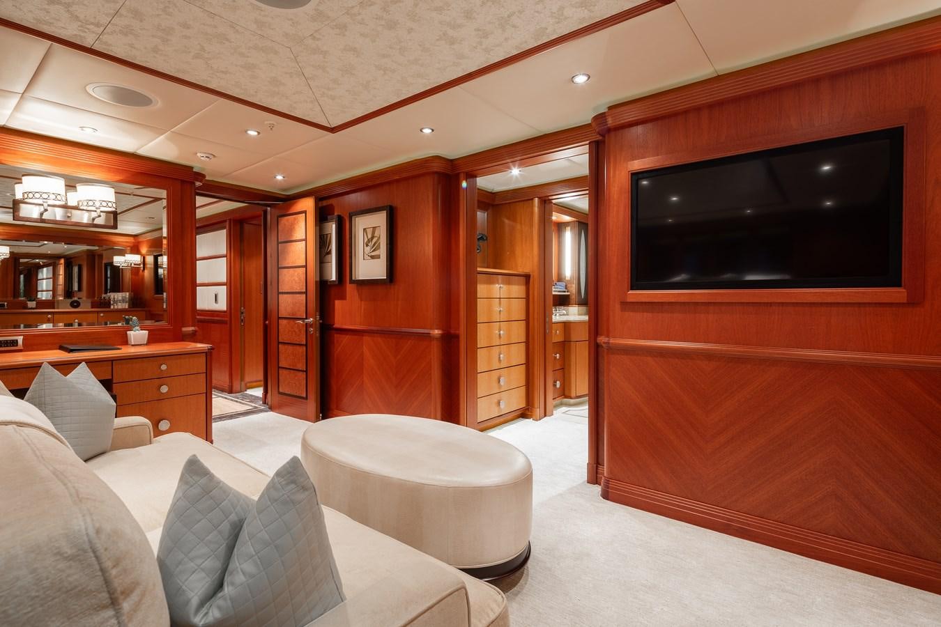 a room with a tv and couch aboard SKYFALL Yacht for Sale