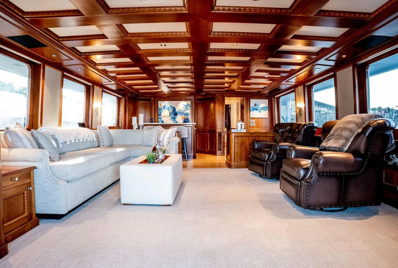 a living room with leather furniture aboard DOZER Yacht for Sale