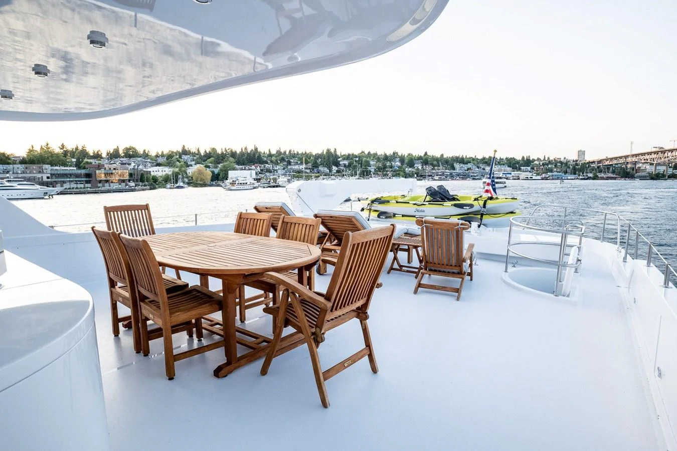 a table and chairs on a snowy patio with boats in the water aboard DOZER Yacht for Sale