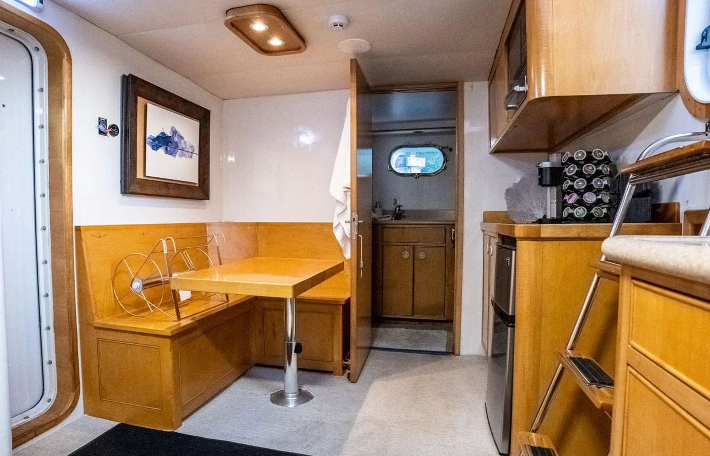 a kitchen with a table and a sink aboard DOZER Yacht for Sale