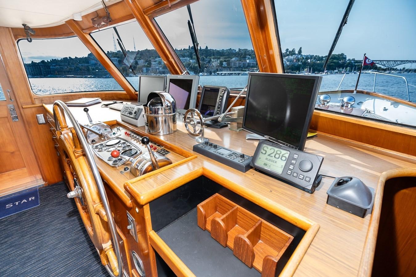 a wooden boat with a computer monitor and keyboard on it aboard SEA STAR Yacht for Sale