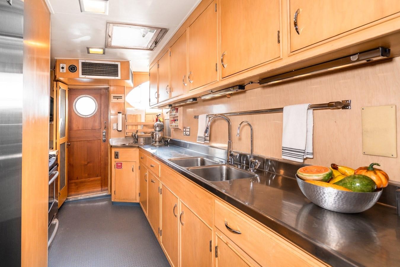 a kitchen with wooden cabinets aboard SEA STAR Yacht for Sale
