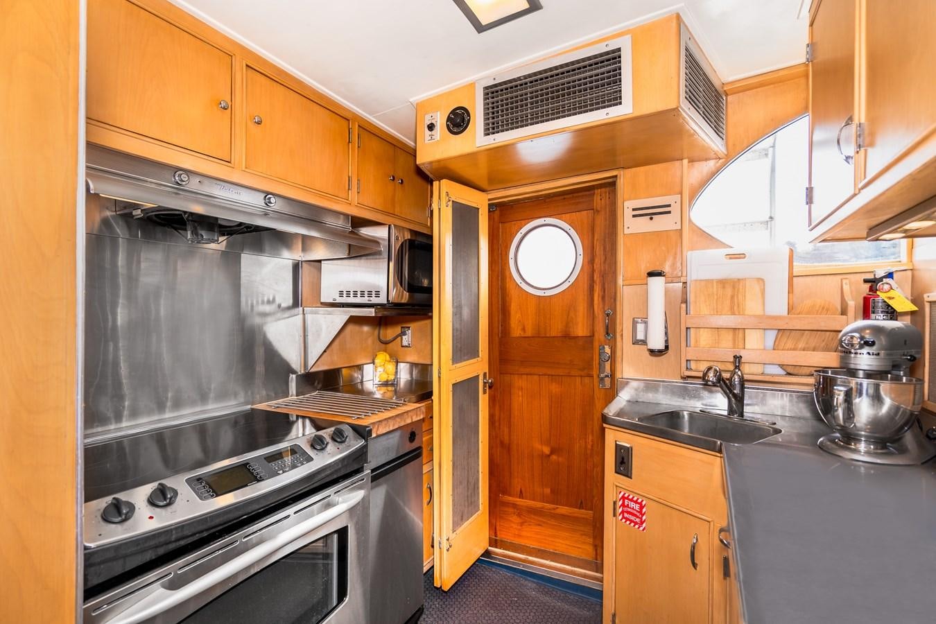 a kitchen with wooden cabinets aboard SEA STAR Yacht for Sale