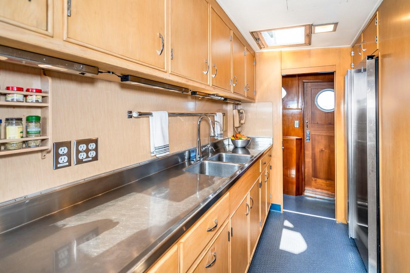 a kitchen with wooden cabinets aboard SEA STAR Yacht for Sale