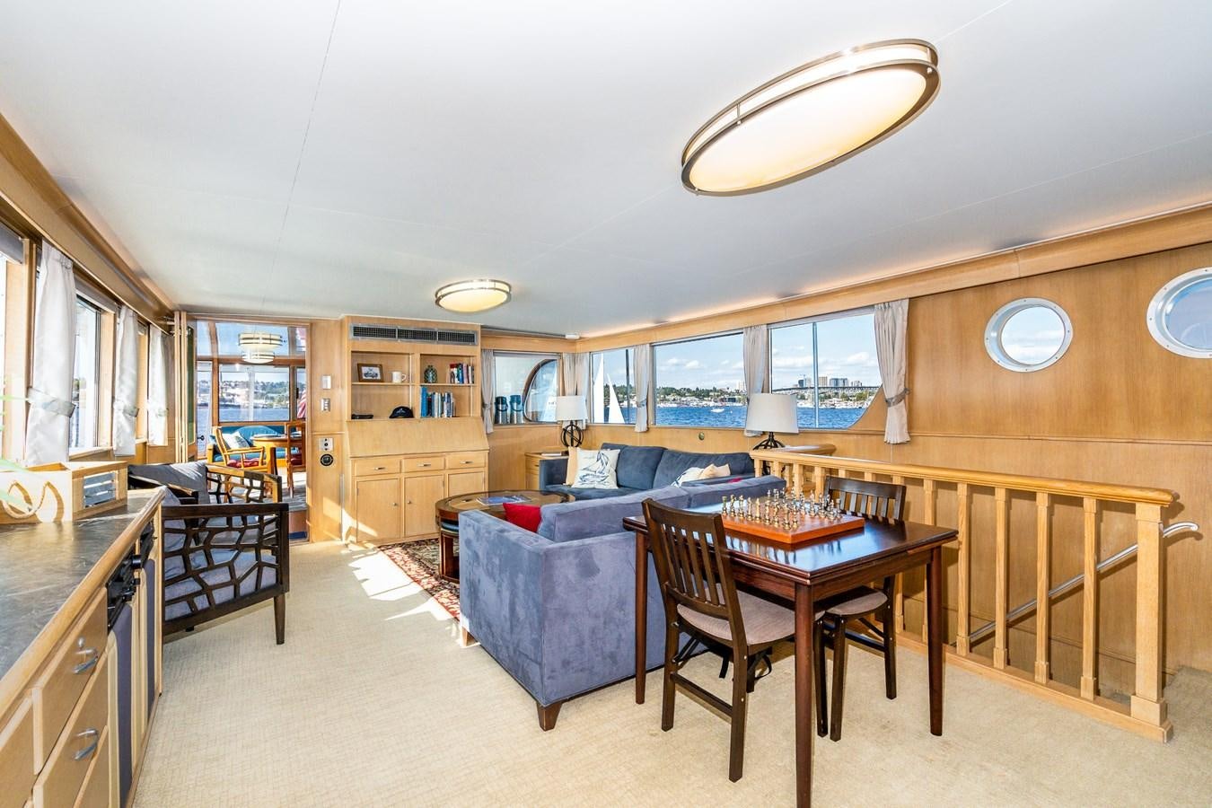 a large living room with a kitchen and dining area aboard SEA STAR Yacht for Sale