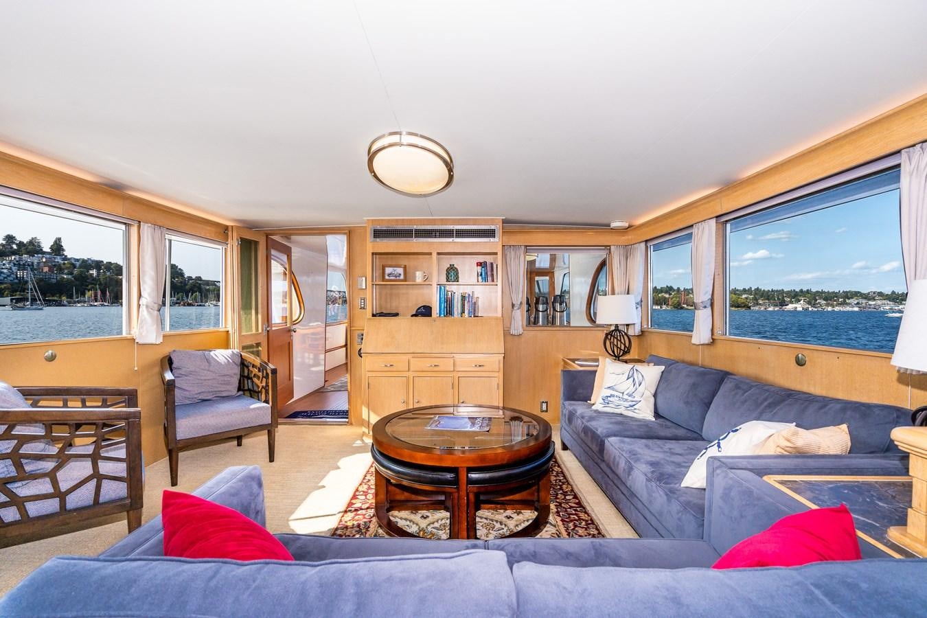 a living room with a large window aboard SEA STAR Yacht for Sale