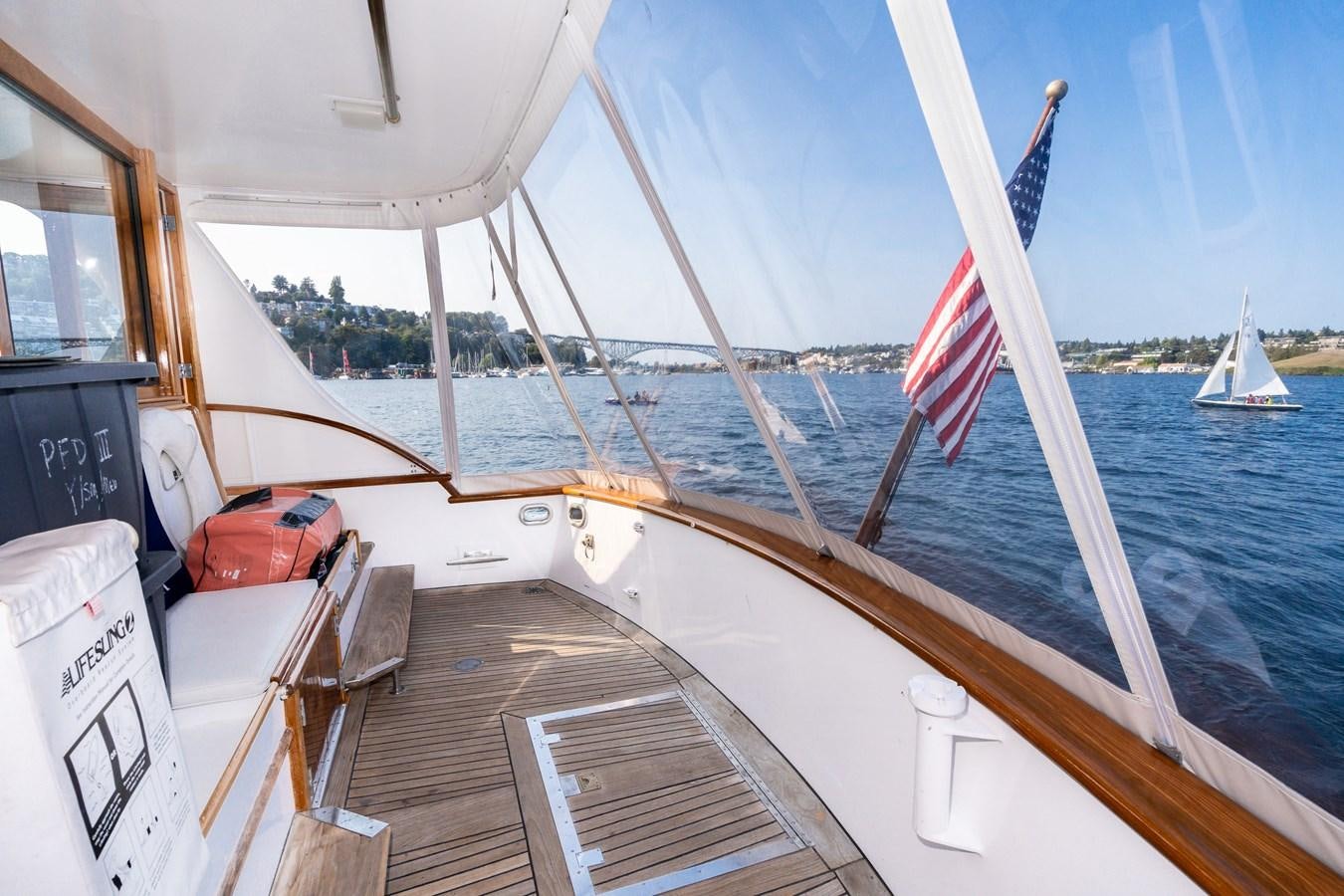 a boat with a flag on the front aboard SEA STAR Yacht for Sale