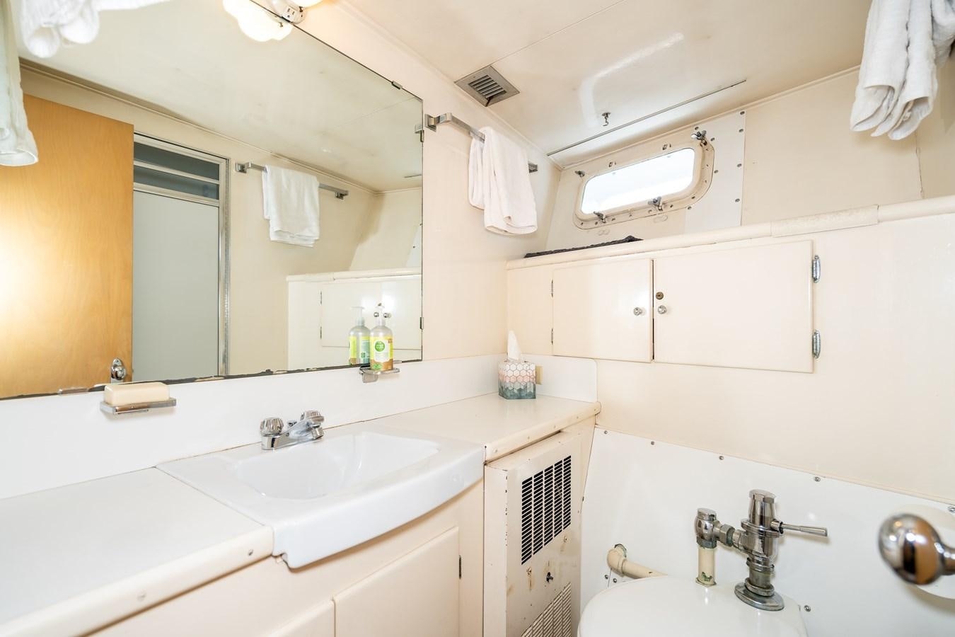 a bathroom with white cabinets aboard SEA STAR Yacht for Sale