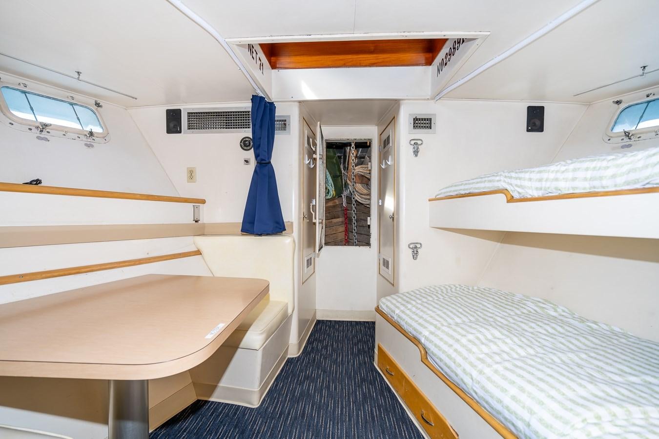 a room with a bed and a table aboard SEA STAR Yacht for Sale