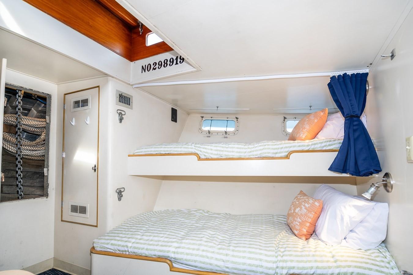 a bed with a blue canopy aboard SEA STAR Yacht for Sale