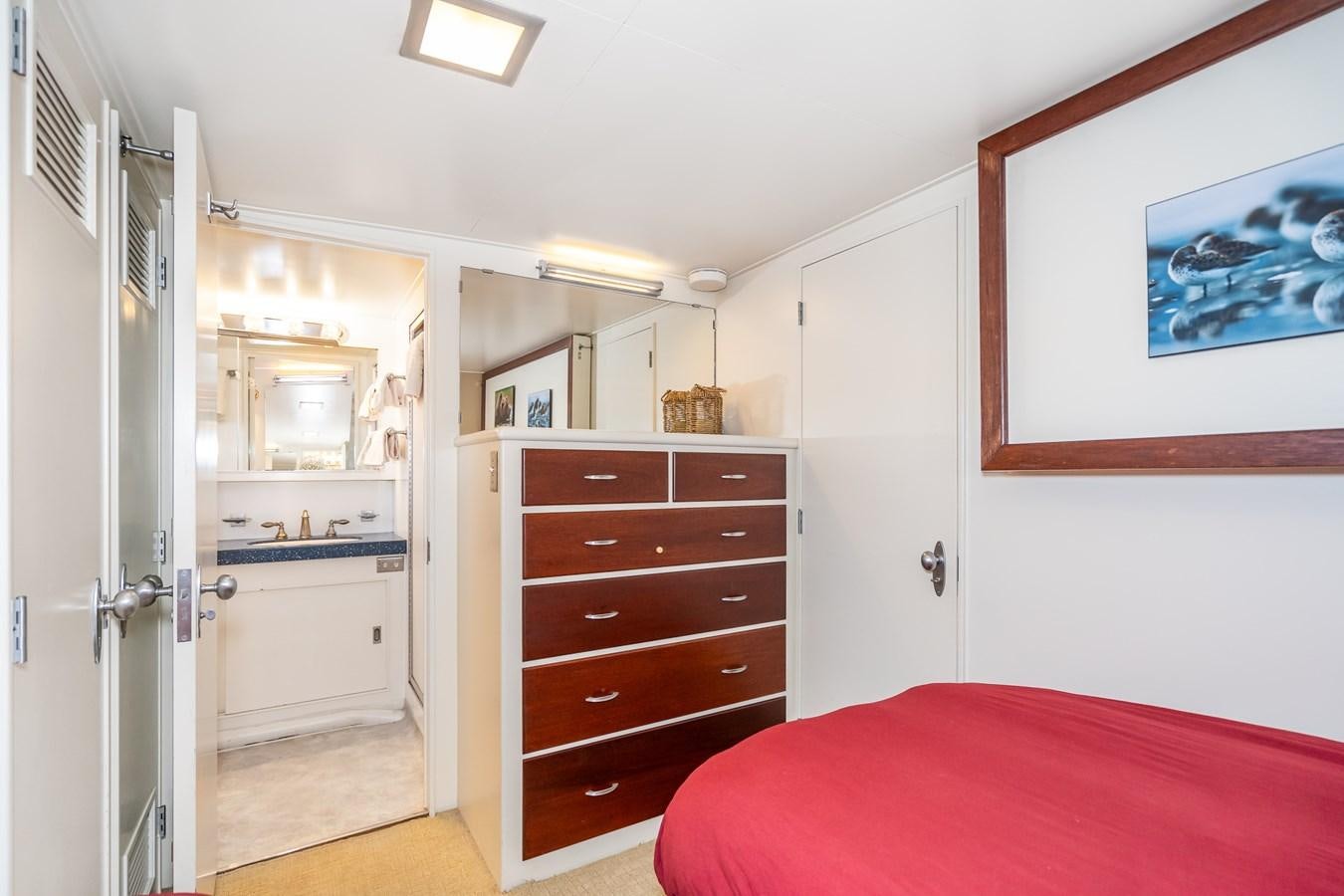 a bedroom with a bed and a closet aboard SEA STAR Yacht for Sale