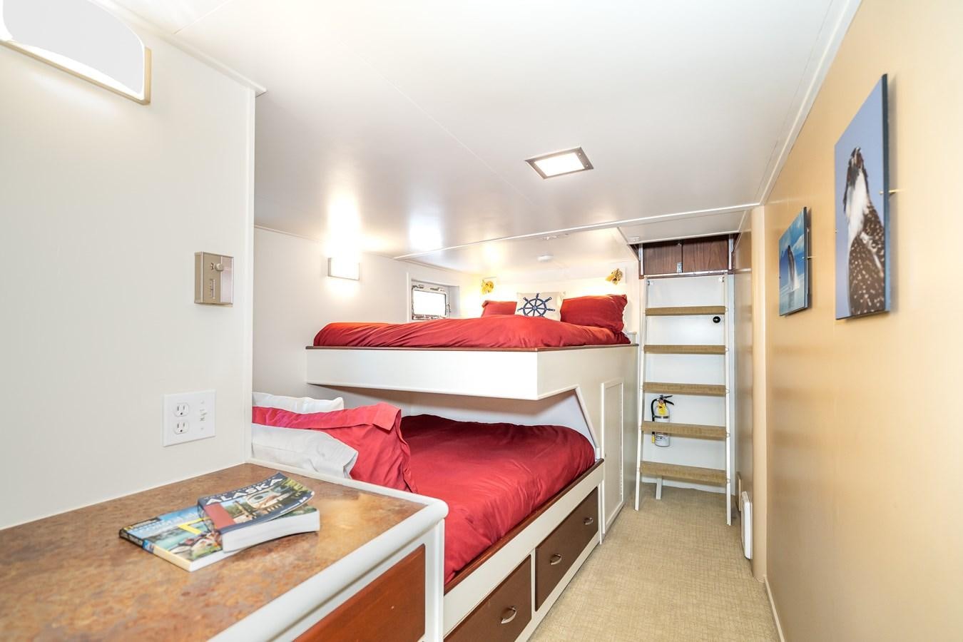 a bedroom with a red couch aboard SEA STAR Yacht for Sale