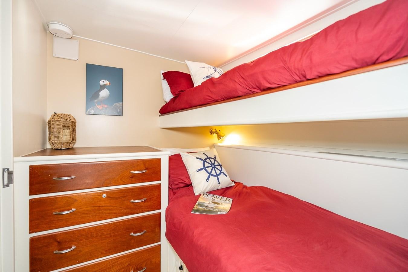 a room with a bed and a dresser aboard SEA STAR Yacht for Sale