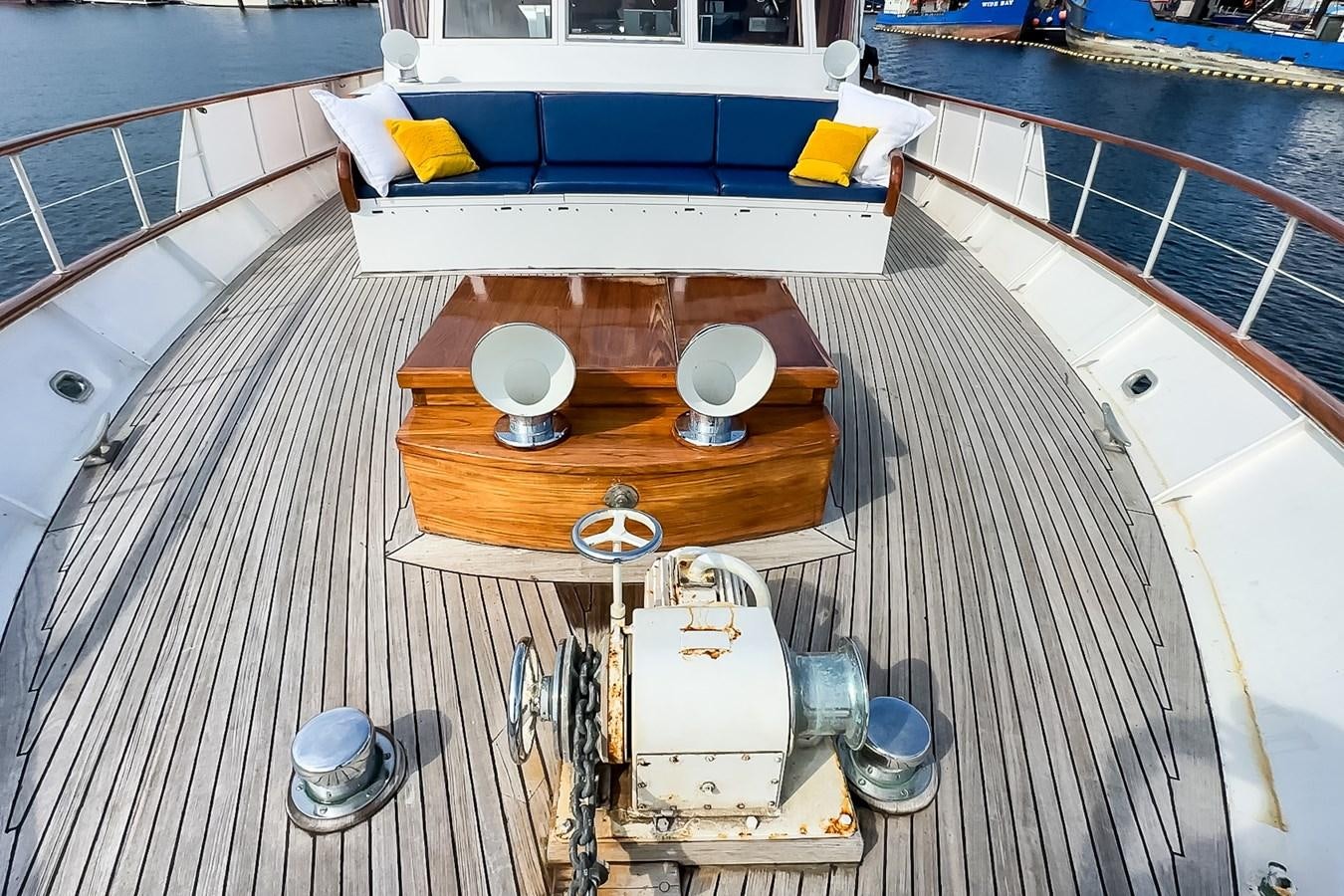 a deck with a table and chairs aboard SEA STAR Yacht for Sale