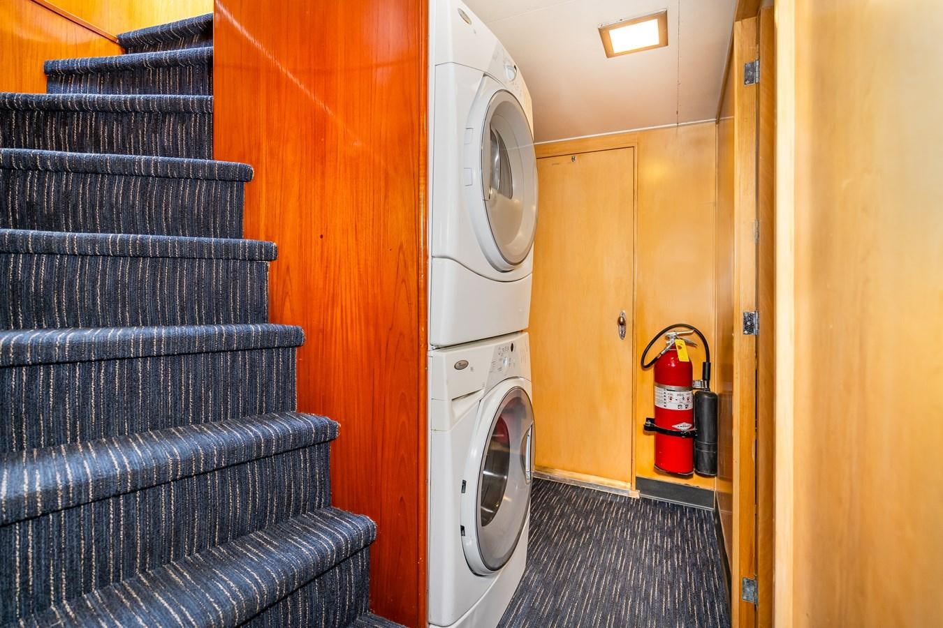 a room with a couch and a washer and dryer aboard SEA STAR Yacht for Sale