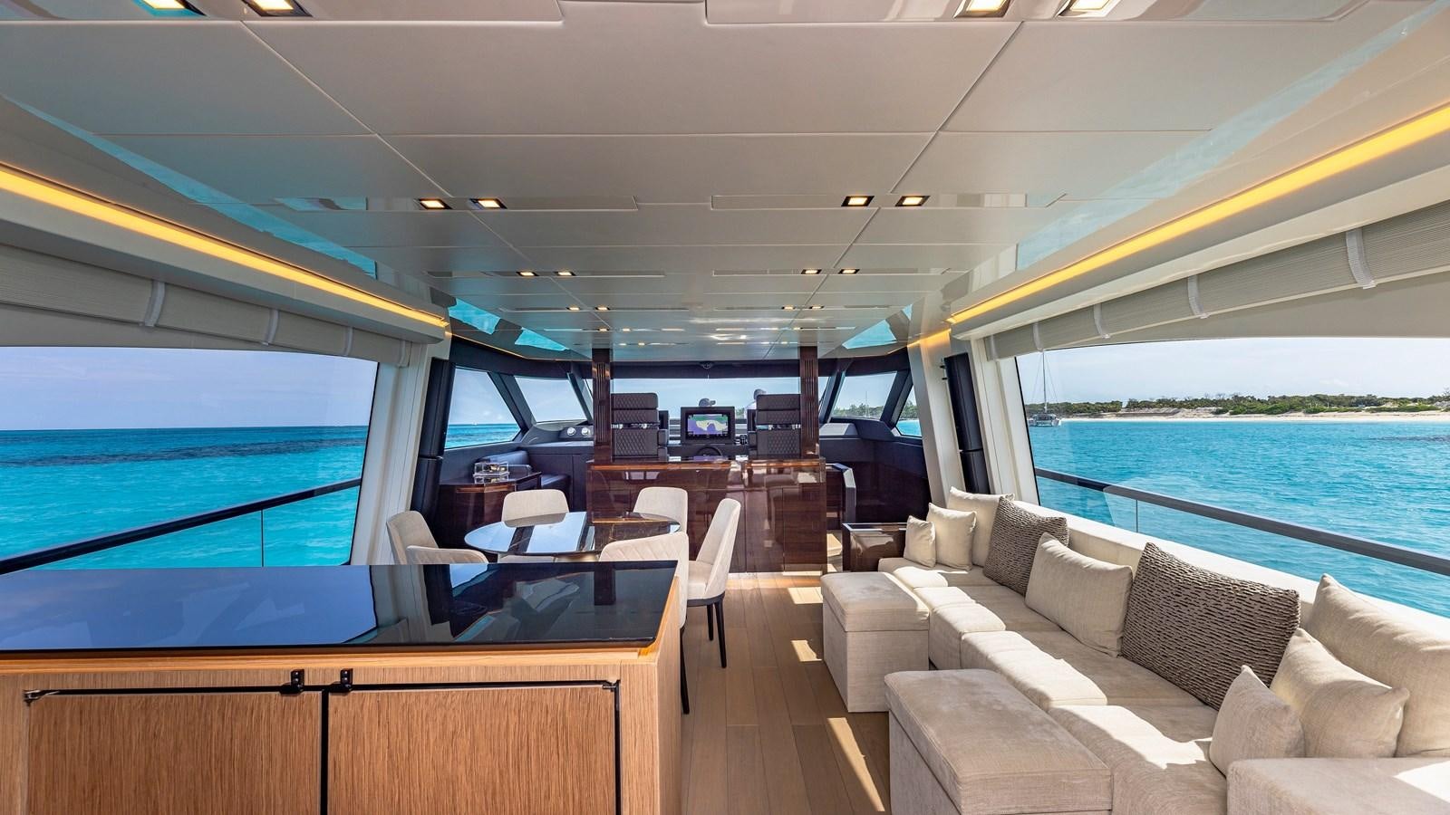 a boat with a couch and a table and chairs aboard INCENTIVIZED Yacht for Sale