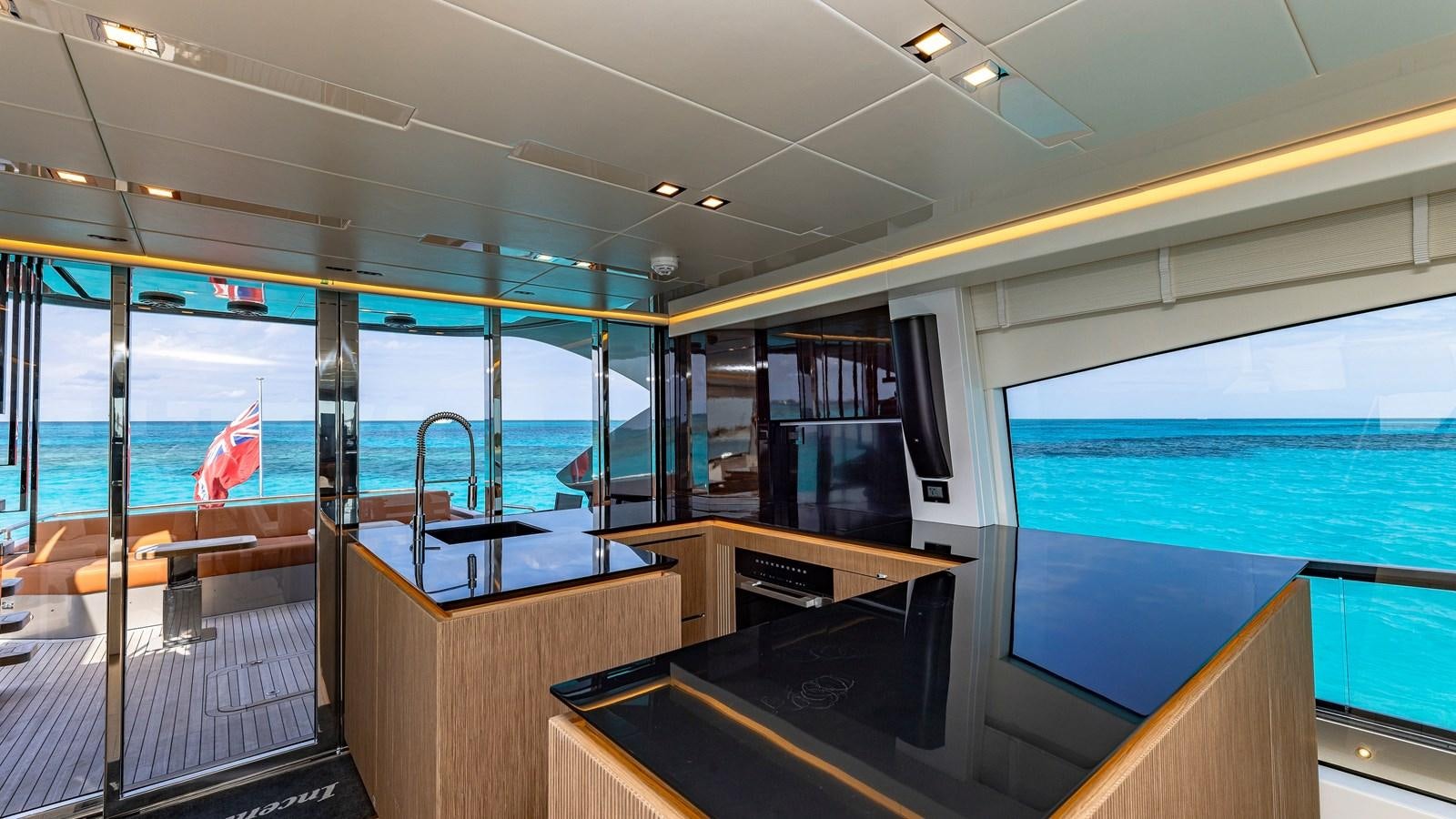 a room with a view of the ocean and a deck aboard INCENTIVIZED Yacht for Sale