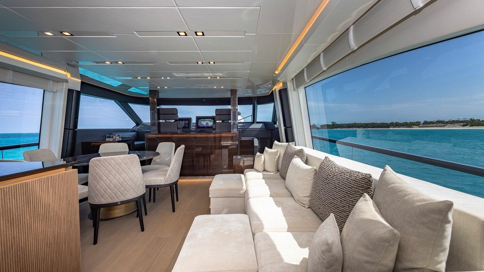 a room with a couch and a table and chairs aboard INCENTIVIZED Yacht for Sale