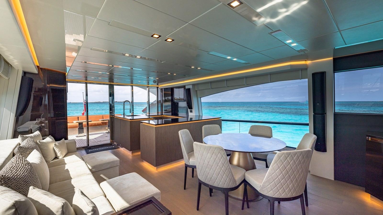 a room with a table chairs and a large window aboard INCENTIVIZED Yacht for Sale