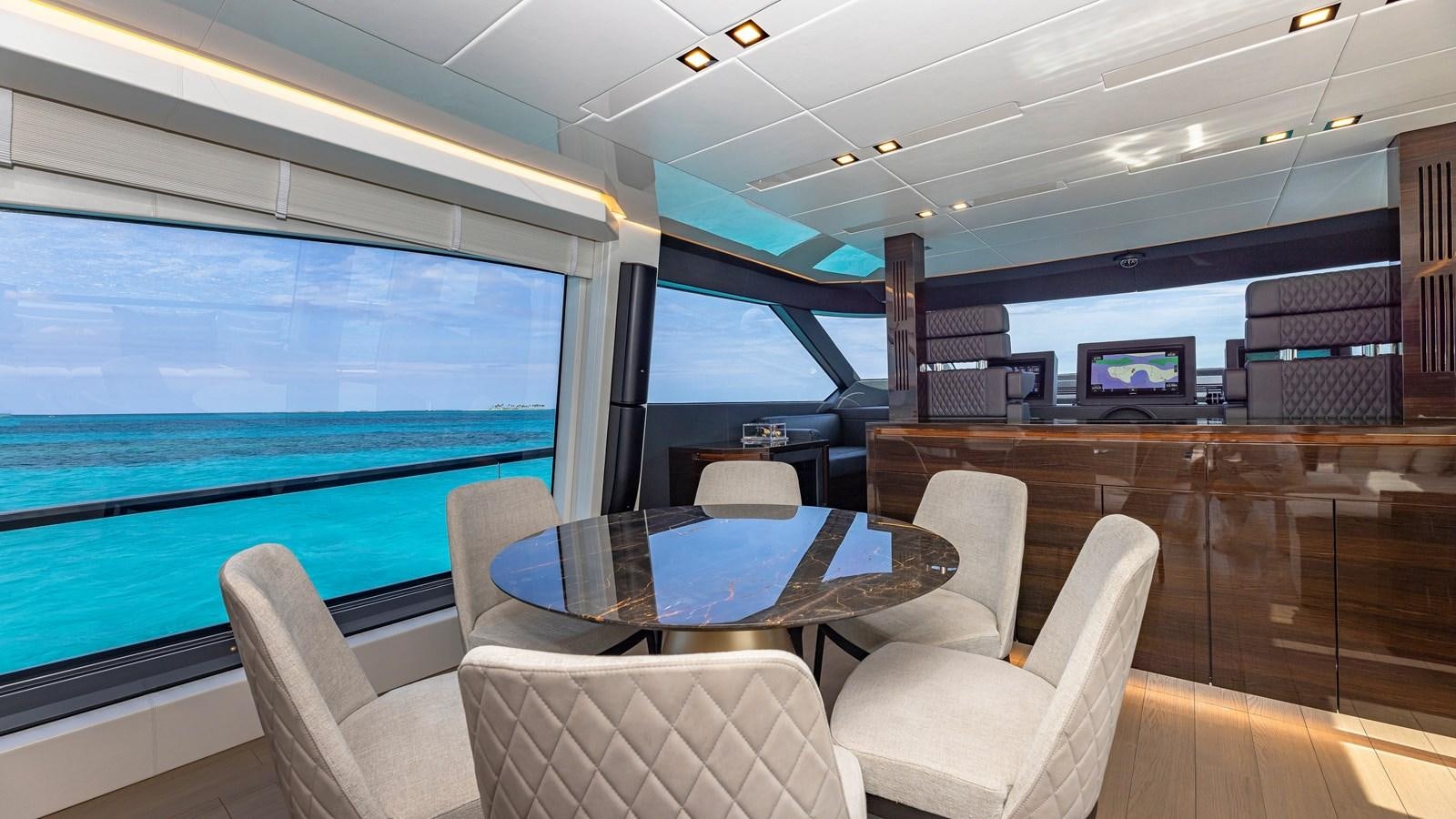 a room with a table and chairs aboard INCENTIVIZED Yacht for Sale