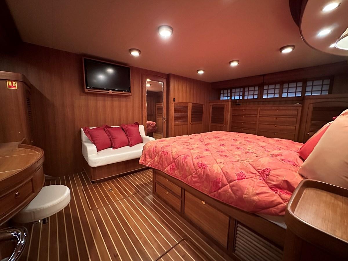 a large bedroom with a bed aboard AZURA Yacht for Sale