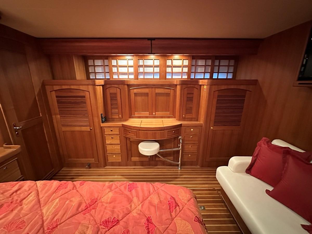 a room with a bed and a table aboard AZURA Yacht for Sale