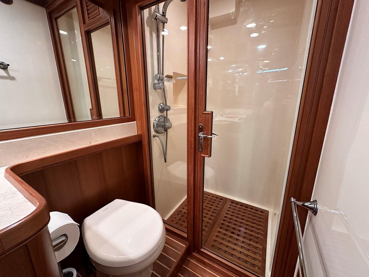 a bathroom with a glass shower door aboard AZURA Yacht for Sale