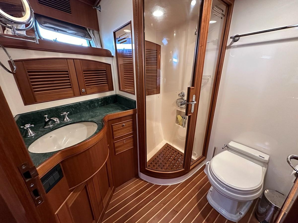 a bathroom with a tub toilet and sink aboard AZURA Yacht for Sale