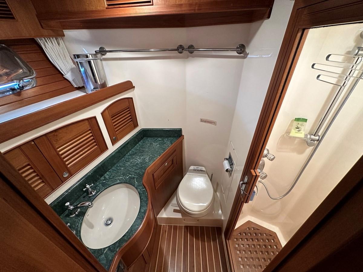 a bathroom with a tub sink and toilet aboard AZURA Yacht for Sale