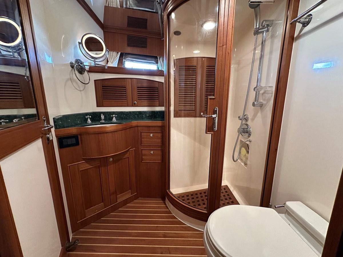a bathroom with a shower and toilet aboard AZURA Yacht for Sale