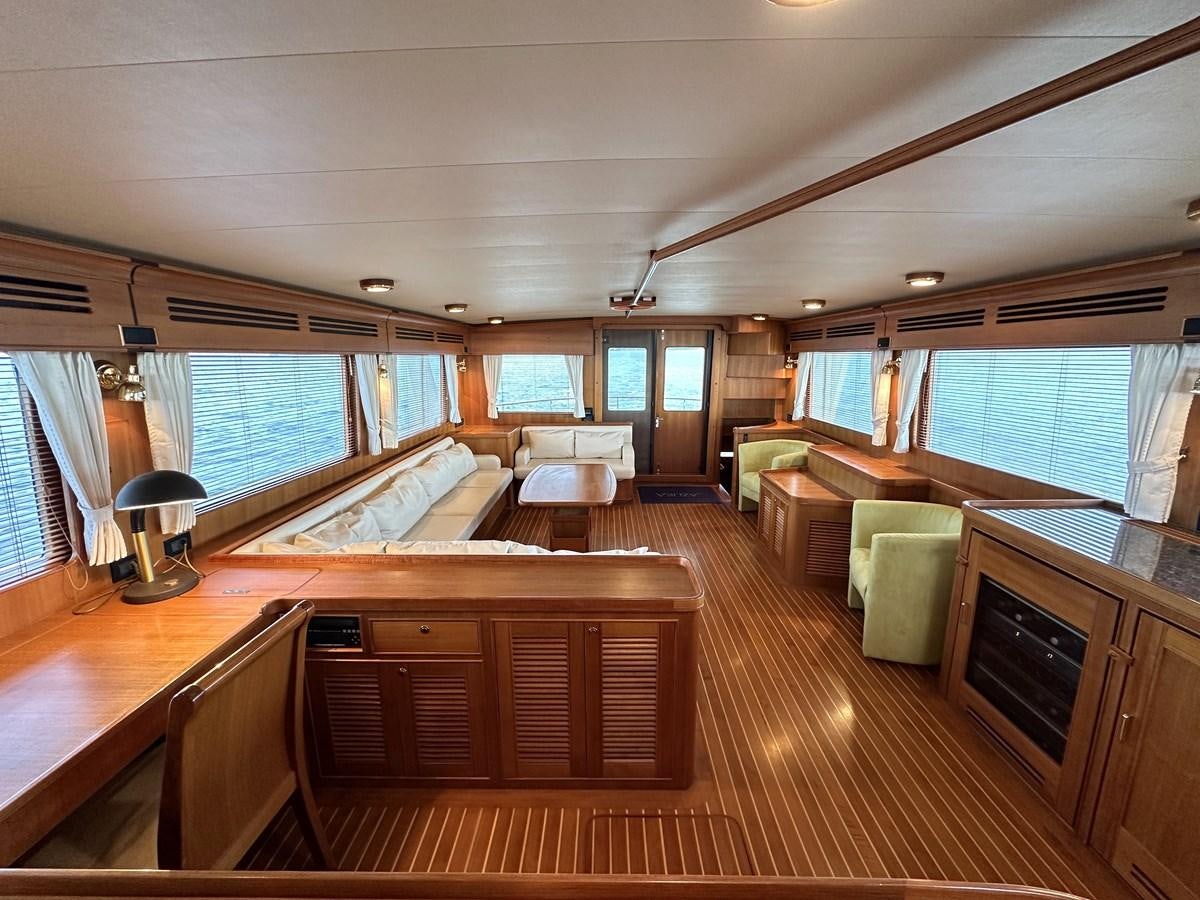 a large room with a wood floor aboard AZURA Yacht for Sale