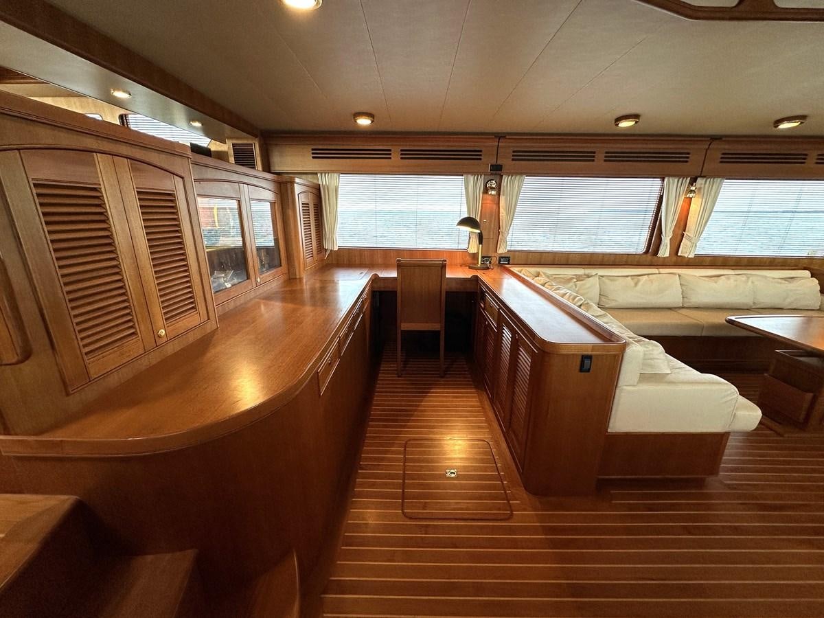 a room with wooden floors and a wood floor and a large window aboard AZURA Yacht for Sale