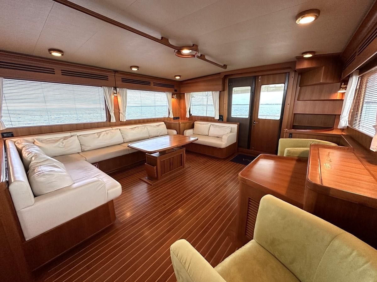 a living room with a couch and a table aboard AZURA Yacht for Sale