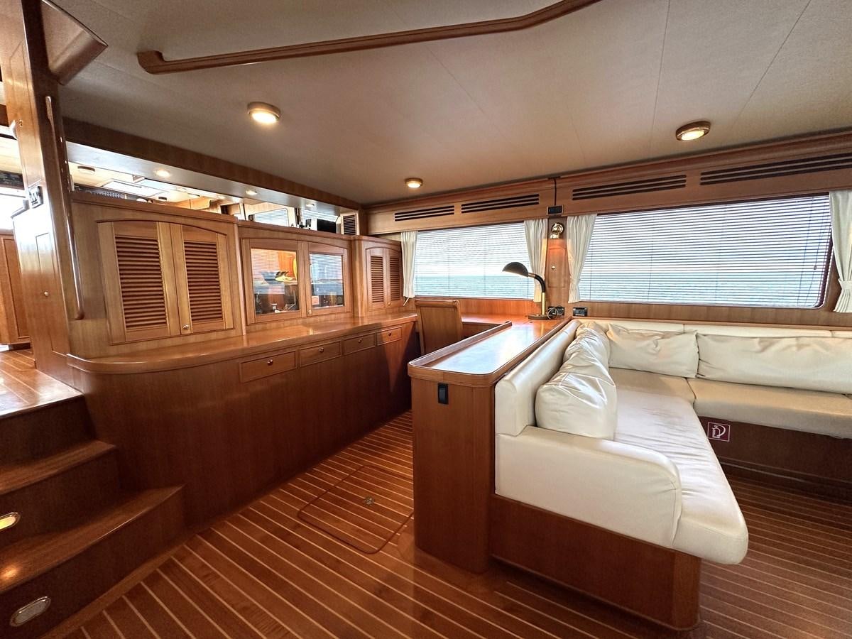 a room with a bed and a large window aboard AZURA Yacht for Sale