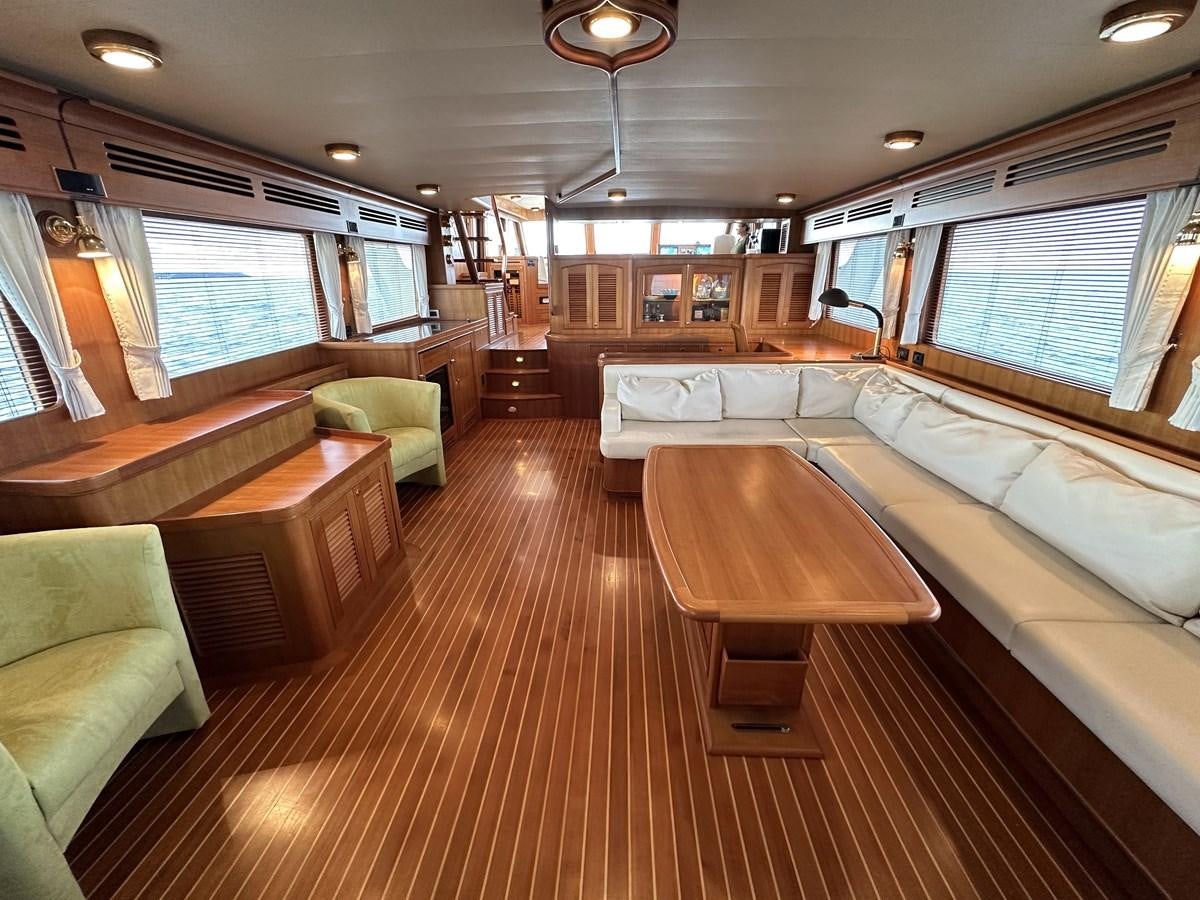 a large living room with a wood floor aboard AZURA Yacht for Sale