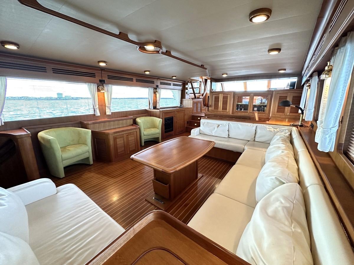 a large room with a table and chairs aboard AZURA Yacht for Sale