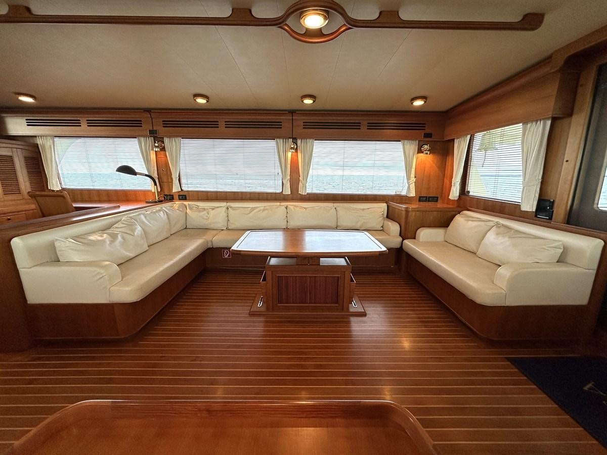 a living room with a wood floor aboard AZURA Yacht for Sale