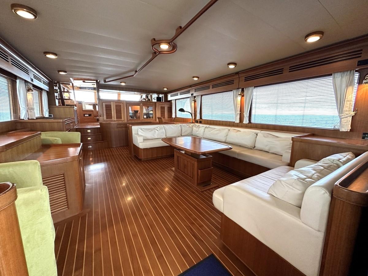 a large living room with a large window aboard AZURA Yacht for Sale
