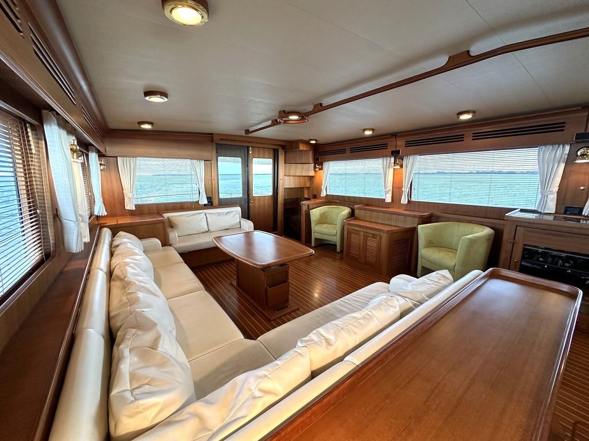 a living room with a couch and a table aboard AZURA Yacht for Sale