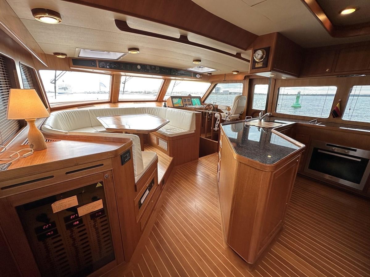 a room with a table and chairs aboard AZURA Yacht for Sale