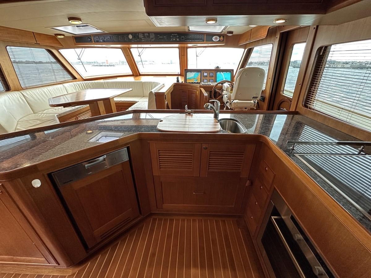 a large kitchen with wooden cabinets aboard AZURA Yacht for Sale