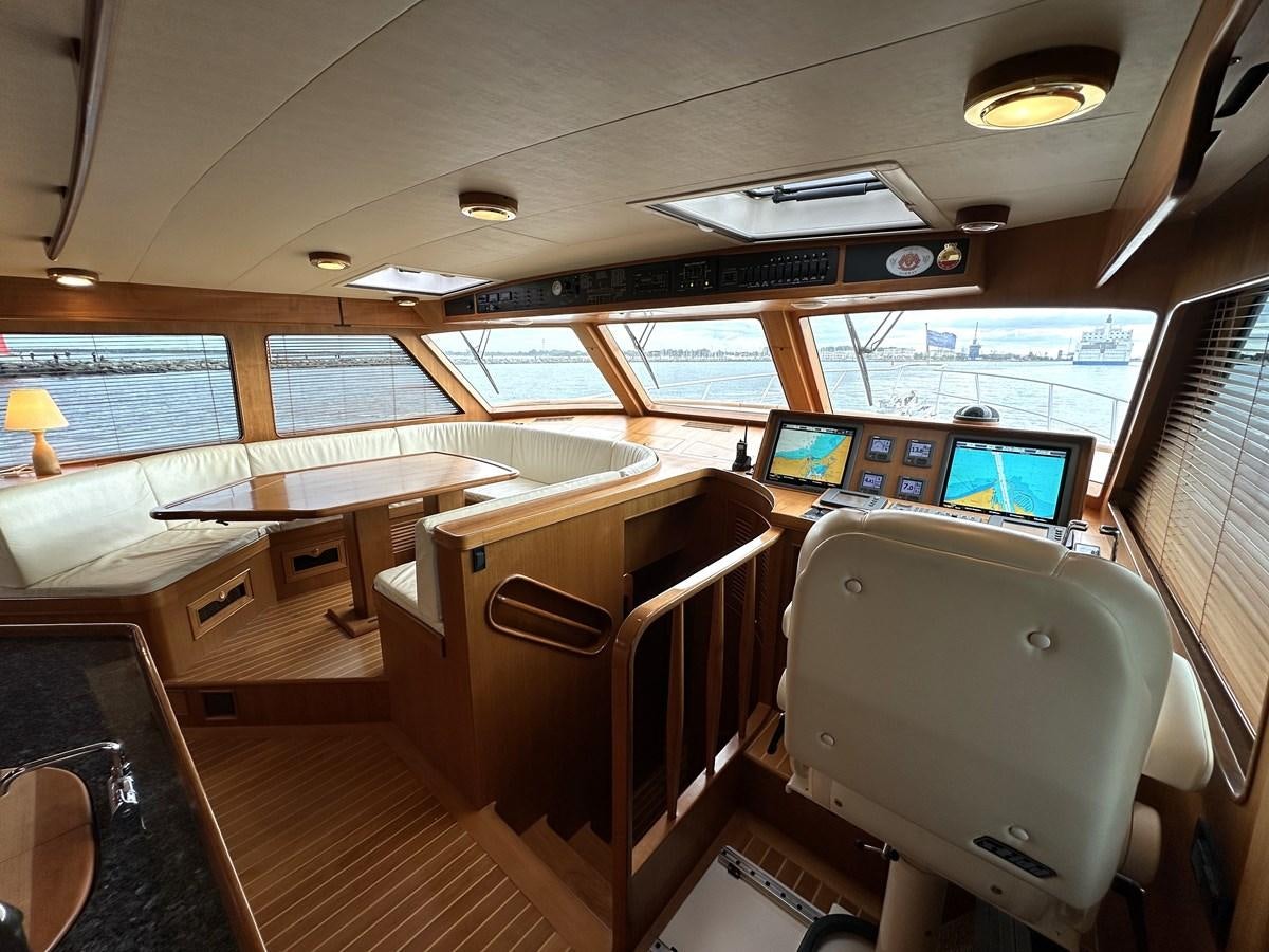 inside of a vehicle with a desk and chairs aboard AZURA Yacht for Sale