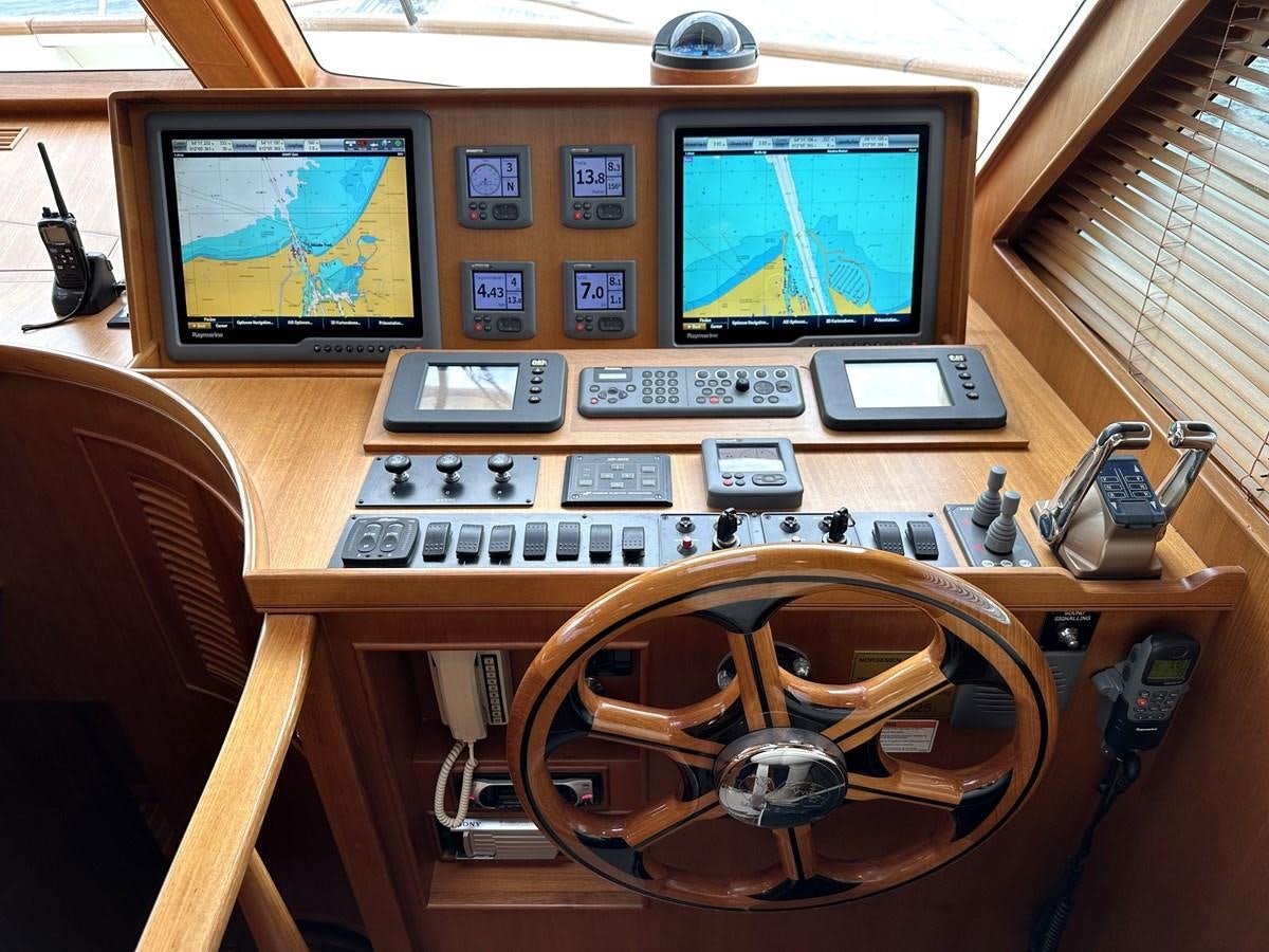 a desk with a computer and a fan aboard AZURA Yacht for Sale
