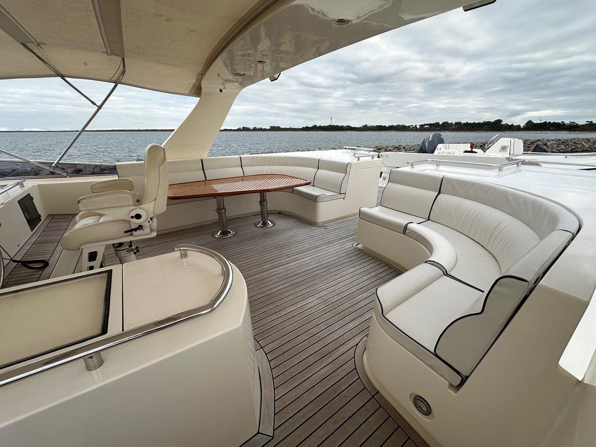 a room with a table and chairs aboard AZURA Yacht for Sale