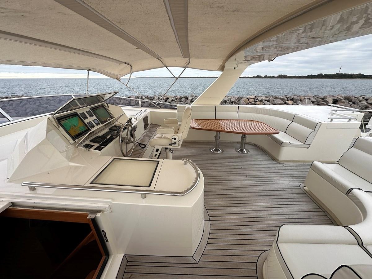 a room with a table and chairs aboard AZURA Yacht for Sale