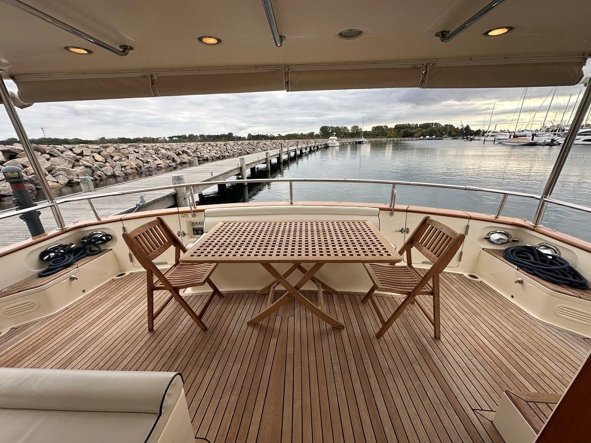 a room with a table and chairs aboard AZURA Yacht for Sale