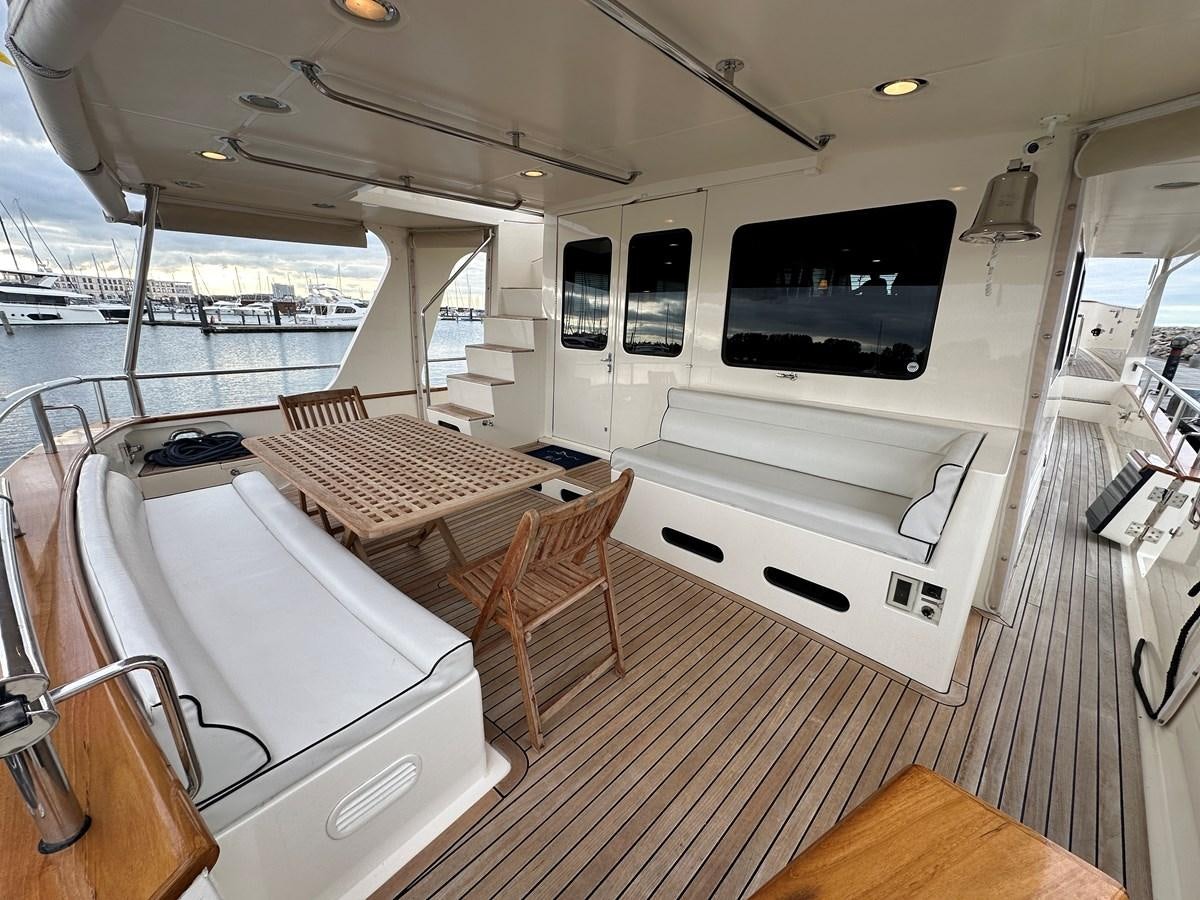 a room with a table and chairs aboard AZURA Yacht for Sale