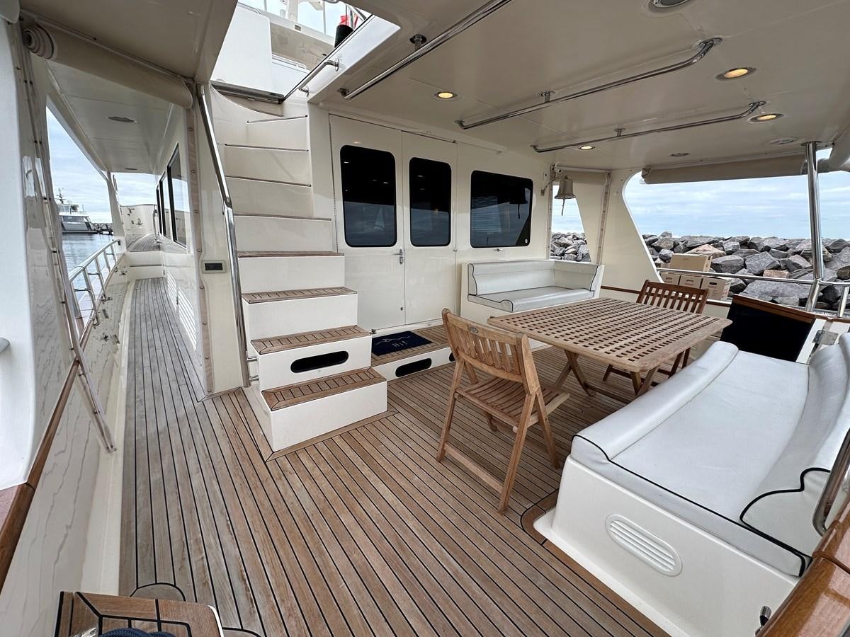 a room with a table chairs and a window aboard AZURA Yacht for Sale