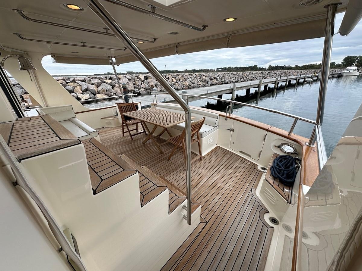 a deck with a view of a city and a large body of water aboard AZURA Yacht for Sale